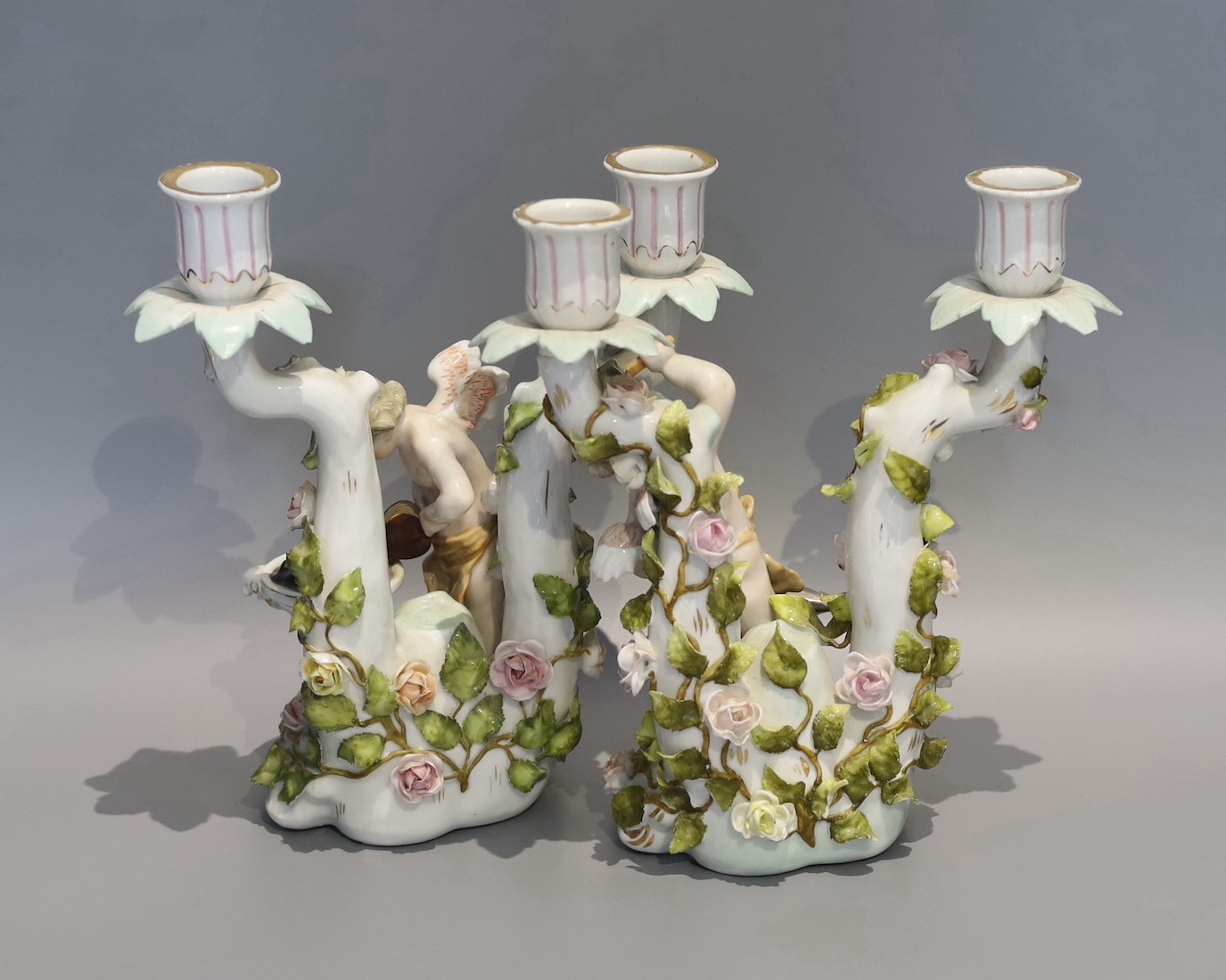 A pair of early 20th century German porcelain two branch candelabra, emblematic of industry, height 24cm